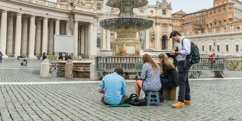 Four students studying at the fountain in Rome