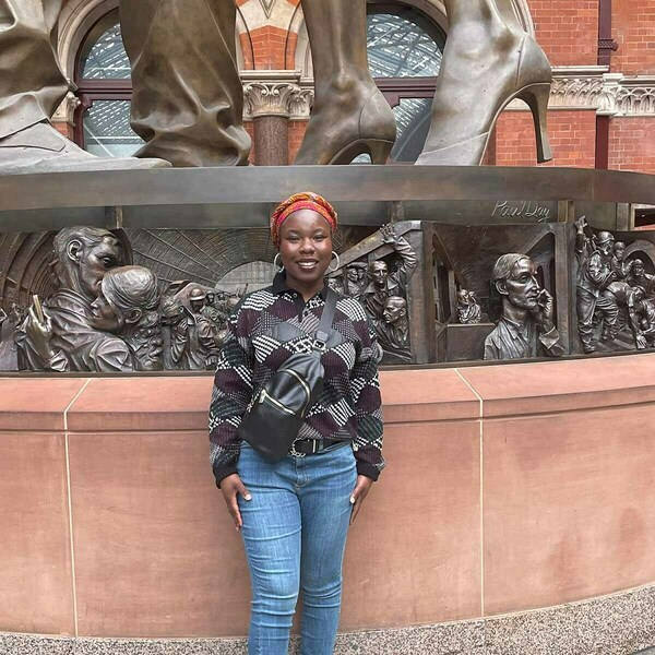 Ida Addo in front of the Meeting Place statue in St. Pancras.