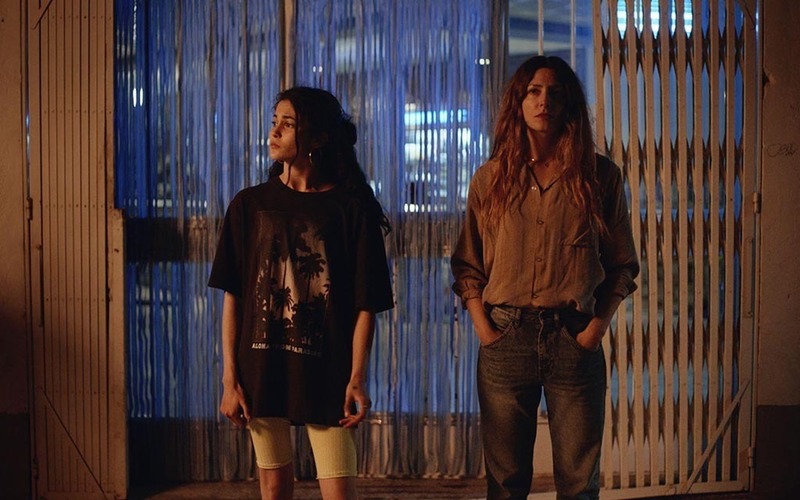 Two women standing outside. Screen capture from El Agua.