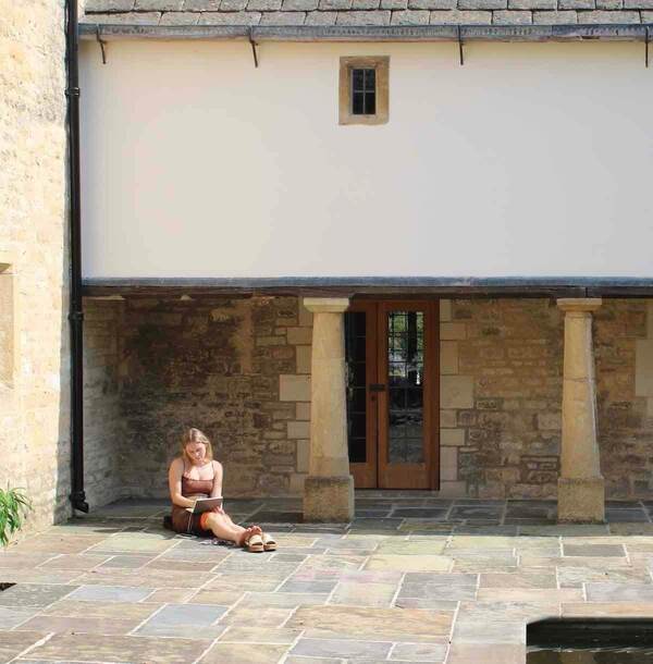 Julia McGibbons drawing in an empty courtyard in the UK's Cotswold district.