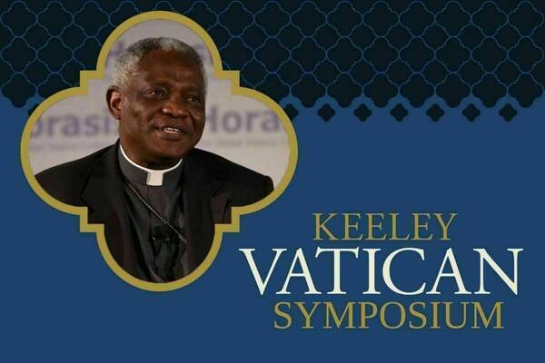 Headshot of a man wearing a clerical collar, inset in a gold quatrefoil on a blue background with a gold quatrefoil pattern. Text reads "KEELEY VATICAN SYMPOSIUM."