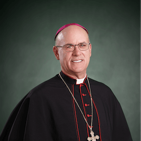 Headshot of Bishop Kevin Rhoades, who is wearing glasses and black/pink religious garments.