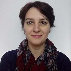 Headshot of Alina Mozolevska, who is wearing a dark scarf and black sweater.