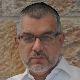Headshot of Yohanan Petrovsky-Shtern, who is wearing a white button-up shirt and thinly-framed glasses.