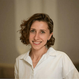 Headshot of Khrystyna Kozak, who is wearing a white shirt.