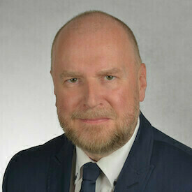Headshot of Yury P. Avvakumov, who is wearing a navy suit and tie.