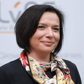 Headshot of Yaryna Boychuk, who is waring a black blazer and multi-colored neck scarf.